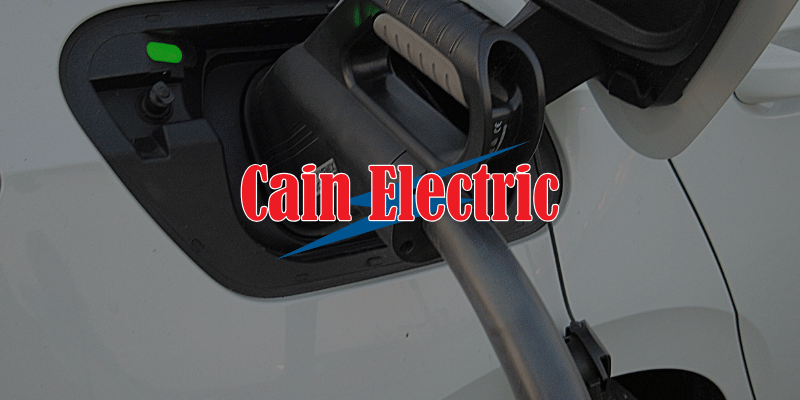 a plugged-in ev charger on a white car