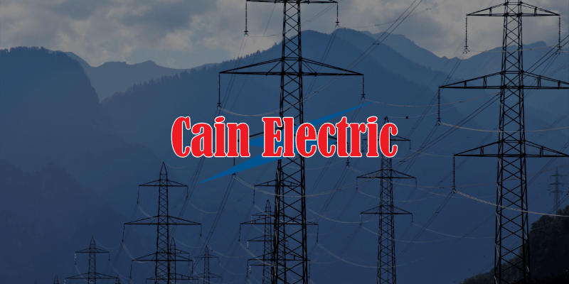 electrical towers, mountains in background