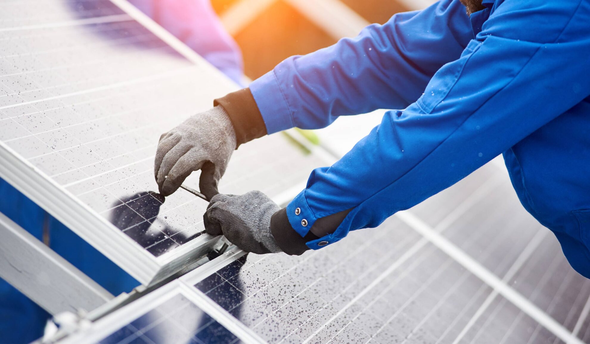 electrician hands close up with gloves and tool installing solar panels gray summit mo