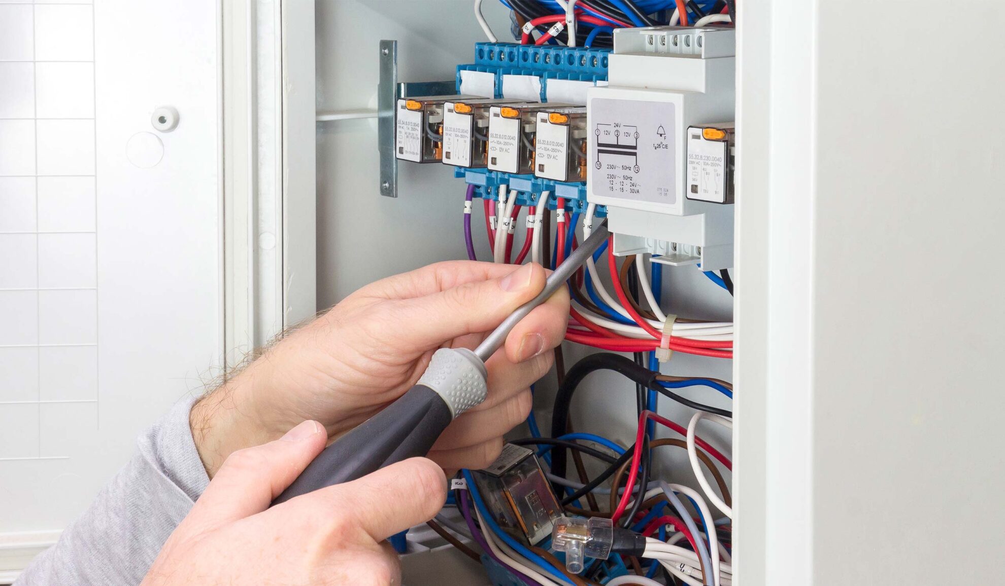 electrician hands with screwdriver close up installing new electrical panel gray summit mo